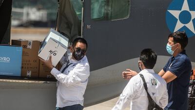 Authorities in Guatemala unload boxes containing 5,000 doses of Covid-19 vaccine donated by Israel. EPA