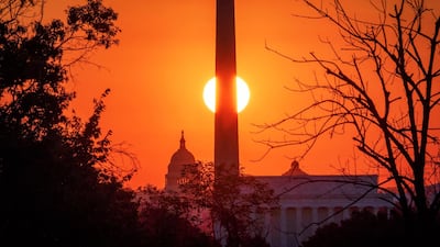 The sun rises behind the Washington Monument on the last day of summer in Washington. AP Photo