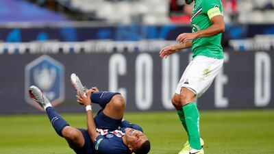 PSG's Kylian Mbappe shouts in pain after being tackled by Saint-Etienne's Loic Perrin, right. AP