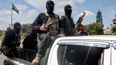 Security forces loyal to the Syrian government travel in the western city of Latakia in March 2025. AFP