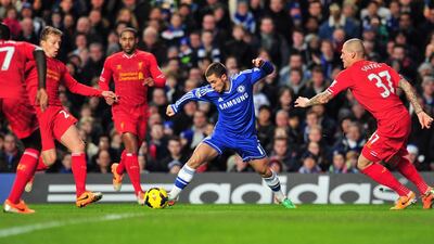 Chelsea's Eden Hazard, centre, weaves his way through the Liverpool defence during his team's 2-1 win on Sunday. Glyn Kirk / AFP