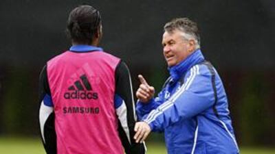 Chelsea's manager Guus Hiddink talks to Didier Drogba during a training session at the team's ground at Cobham.