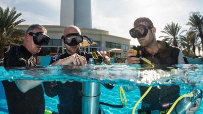 Petr Kopfstein of the Czech Republic and Hannes Arch of Austria seen during the underwater rescue training before the first stage of the Red Bull Air Race World Championship in Abu Dhabi. Predrag Vuckovic / Red Bull
