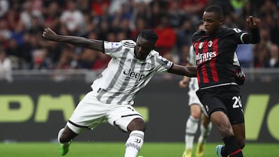 Juventus striker Moise Kean of Juventus is challenged by AC Milan defender Pierre Kalulu. Getty