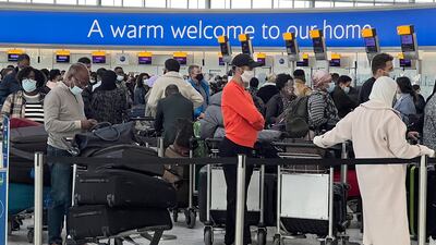 Passengers queue to check in at Heathrow Airport, where passenger numbers slumped because of Covid-19. AP