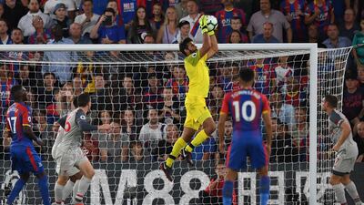 Liverpool goalkeeper Alisson Becker leaps to claim a cross. EPA