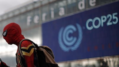 A man dressed in a Spiderman costume walks outside of the COP25 climate talks congress in Madrid, Spain. AP Phot