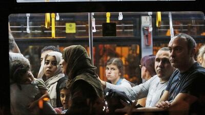 Passengers leave on a bus from Istanbul’s Ataturk airport. Attackers began spraying bullets at the international terminal entrance before blowing themselves up at around 10pm (11pm UAE) Tuesday. Emrah Gurel / AP Photo