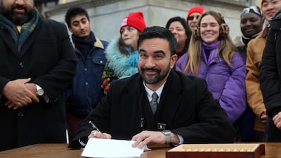 Zohran Mamdani signs executive orders with campaign volunteers during an appearance at Grand Army Plaza in Brooklyn. Getty Images / AFP