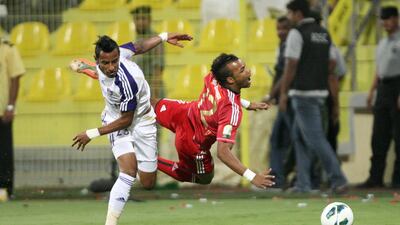 Dubai, United Arab Emirates, Sep 17, 2012 - Luis Fernando da Silva(left) from Al Jazira fight for the ball with from Mohamed Ahmad from Al Ain during the Super Cup final match at Al Wasl Sports Club. ( Jaime Puebla / The National Newspaper )