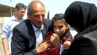The parents of Palestinian Dima Al Wawi, 12, who is believed to be the youngest female detained by Israel, greet her in the West Bank city of Tulkarem, upon her release from Israeli prison on April 24, 2016. Jaafar Ashtiyeh/AFP
