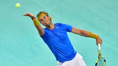 TOPSHOT - Spanish's Rafael Nadal serves the ball to South Africa’s Kevin Anderson during the Mubadala World Tennis Championship 2018 first Semi-final match in Abu Dhabi, on December 28, 2018. / AFP / GIUSEPPE CACACE