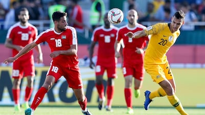 Australia's Trent Sainsbury, right, and Palestine's Day Dabbagh go for the ball. AP Photo