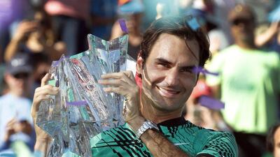 Roger Federer of Switzerland holds the trophy after defeating Stan Wawrinka of Switzerlad in the men's finals match at the 2017 BNP Paribas Open tennis tournament at the Indian Wells Tennis Garden in Indian Wells, California, USA, 19 March 2017. Paul Buck / EPA