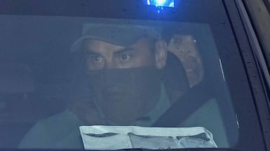 Daniel Kinahan, in the back of a police car, leaving a court in Dublin where he was remanded in custody charged with directing an organised crime group, after being extradited from Dubai. Getty Images