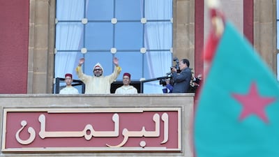 In this photo provided by the Moroccan Palace, Moroccan King Mohammed VI waves to the crowd after he delivers a speech during the opening session in the Morocco Parliament in Rabat. Moroccan Royal Palace / The Associated Press