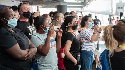 Visitors at the Brazilian pavilion enjoy watching the freestyle footballers' performance.