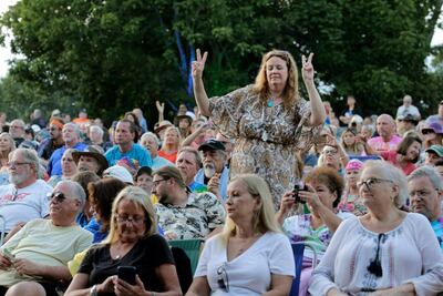 Music fans listen to the band Blood, Sweat and Tears play at a concert on the 50th anniversary of Woodstock. Seth Wenig / AP