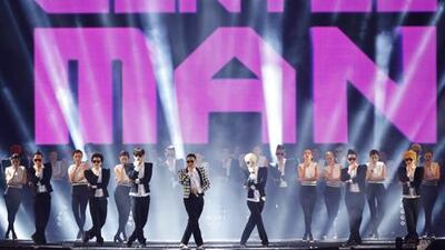 South Korean rapper Psy, in a checkered jacket, performs his new song 'Gentleman' in his concert titled 'Happening' in Seoul. AP Photo / Kin Cheung