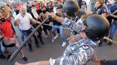 A police officer falls down during clashes with anti-government protesters on a road leading to the parliament building in downtown Beirut. AP Photo