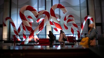 People walk around Christmas decorations as the global outbreak of the coronavirus disease (COVID-19) continues, in New York City, U.S. REUTERS