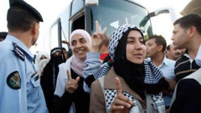 Pro-Palestinian activists who were aboard the Gaza-bound aid flotilla raided by Israel cross the King Hussein Bridge in Shuneh, west of Amman, Jordan from the Israeli-controlled Allenby Bridge.