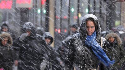 Pedestrians make their way through snow in New York. More than 35 million people along the Philadelphia-to-Boston corridor rushed to get home and settle in as a fearsome storm swirled in with the potential of 1 to 3 feet of snow that could paralyse the Northeast for days. Seth Wenig / AP
