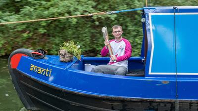 Aaron Ciesar carries the baton along a river in Solihull. Getty Images