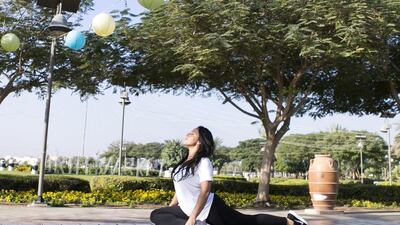 Yoga instructor Dareen Abdullah, wearing Lululemon activewear, at Barsha Pond Park, Dubai. She spends up to Dh4,000 a month on fitness brands, making aesthetics a priority. Reem Mohammed / The National