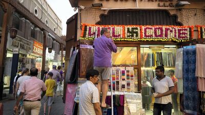 A shop keeper puts of festive lights outside his business on “Hindi Lane” in Bur Dubai, ahead of Diwali in 2019. Antonie Robertson / The National