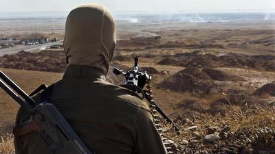 A member of Kurdish Peshmerga forces takes position overlooking militants of the Islamic State of Iraq and the Levant (ISIL) positions in Jalawla in the Diyala province, on June 14, 2014. A major offensive by militants, spearheaded by jihadists from the Islamic State of Iraq and the Levant but involving other groups, overran all of Nineveh and chunks of three more provinces in a matter of days. Rick Findler / AFP photo