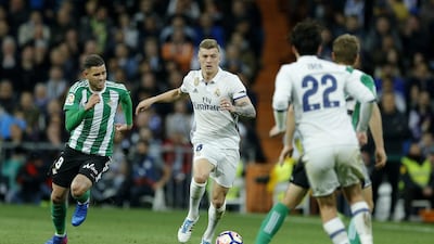 Real Madrid’s Toni Kroos, second left, fights for the ball with Real Betis’ Arnaldo Sanabria, left. Francisco Seco / AP Photo