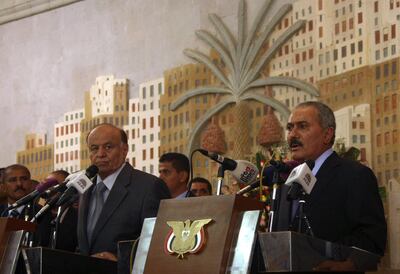 Yemen's former president Ali Abdullah Saleh, who stepped down after 33-years at the helm, addresses a ceremony at the presidential palace, formally handing power to his deputy, and now president Abdurabbu Mansur Hadi (L) in Sanaa, on February 27, 2012. Mohammed Huwais / AFP