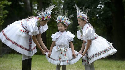 A woman and two small girls pose in traditional dresses of the style of village Rimoc during a Paloc festival honouring St Anna in Balassagyarmat, 80kms north of Budapest, Hungary. The Paloc are a group of Hungarian ethnicity with their own traditions, folk art and dialect living in a region in northern Hungary. EPA