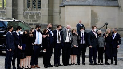 Family members of the former secretary of state stand together outside the cathedral. EPA