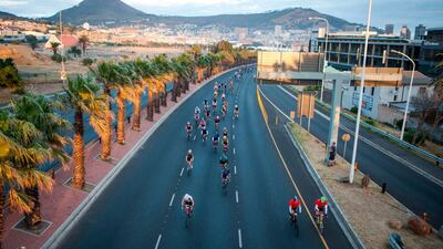 Riders pass a scenic view of the city of Cape Town and Signal Hill during the 40th edition of the Cape Town Cycle Tour. Wikus de Wet / AFP