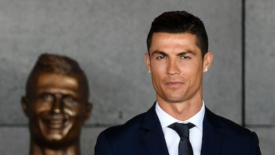 Ronaldo next to the original bust unveiled at a ceremony to rename the Madeira airport after the Portuguese star. AFP