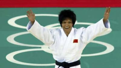 Xian Dongmei of China celebrates after defeating An Kum Ae of North Korea during their women's 52kg final judo match.