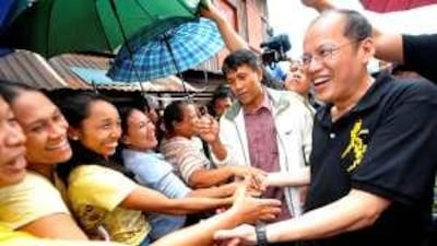 Senator Benigno Aquino, the son of the late Philippines president Corazon Aquino, greets supporters.