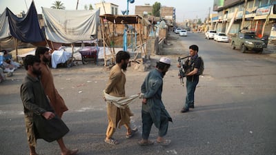 Tied together people, who fled a prison after a militant attack, walk along a road after they were captured by Afghan security officials in Jalalabad, Afghanistan. EPA