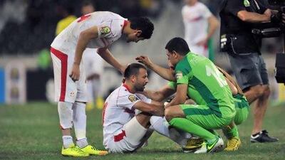 Tunisia national football team's players react after Togo qualified into the quarter-final at the end of the Africa Cup of Nations 2013 group D football match Togo vs Tunisia on January 30, 2013 at the Mbombela stadium in Nelspruit. AFP PHOTO / ISSOUF SANOGO *** Local Caption *** 379962-01-08.jpg
