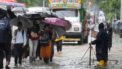 Many train stations remained inundated, forcing commuters to wade through knee-deep water. AP Photo