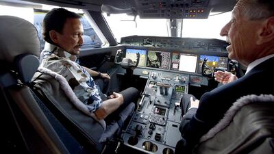 Brunei’s Sultan Hassanal Bolkiah, left, listens to Gulfstream’s captain of flight operations Bob McKenney in the cockpit of a Gulfstream G650 aircraft at the Singapore Airshow. Edgar Su / Reuters