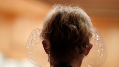 A woman wears orchestra conductor Ivan Fischer's acoustic mask at the Mupa Budapest. Reuters