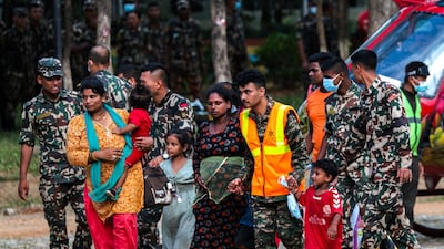 Army personnel help people who were airlifted from a site affected by flash floods and a mudslide in Trishuli, the Nuwakot district of Nepal. Reuters