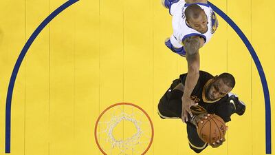 Cleveland Cavaliers forward LeBron James, bottom, shoots against Golden State Warriors forward Andre Iguodala during the second half of Game 7 of the NBA Finals at Oakland, California on Sunday. John G Mabanglo / AP Photo