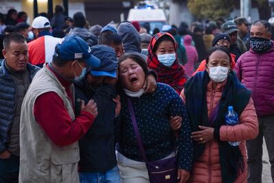 People weep at a hospital receiving bodies of victims of the plane crash in Pokhara, Nepal, on Sunday. AP