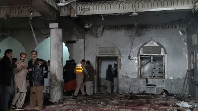 Security personnel inspect a mosque after a bomb blast in Peshawar, north-west Pakistan, on Friday, March 4. The explosion killed at least 30 people and wounded 56. AFP