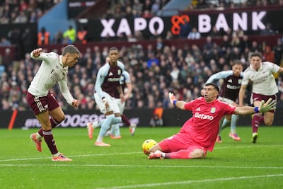 Arsenal's Leandro Trossard, left, sees his shot saved by Aston Villa goalkeeper Emi Martinez. AP