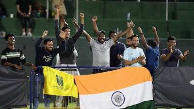 Supporters of Minerva Academy celebrate after seeing their team win the U12 Mina Cup final.